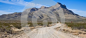 Scenic route 66 desert highway view at midday with clear sky and mountain background landscape
