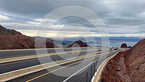 Scenic Route Overlooking Lake Mead, A highway winds through the desert with a panoramic view of Lake Mead in the