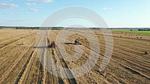 Scenic Rural Landscape Combines Harvests Wheat In Field At Sunset