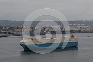 Scenic San Diego Bay vista with a hybrid solar ship passing by under a heavily overcast sky, California