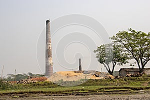 Scenic scenery of a brick kiln and sky. Brick kiln and village area scenery with blue sky. A beautiful rural area on the bank of a