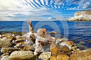 Scenic seascape with blue water, rocks and dramatic sky in Crimea, Ukraine