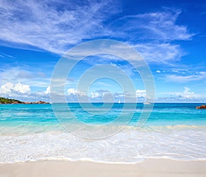 Scenic seascape with white sand on the beach and ocean`s turquoise water. Idyllic tropical beach scene. Seychelles