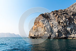 Scenic seaside surrounded by desert rocks in Khasab Oman