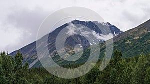 Scenic shot of the Alaska Range in the Southcentral region of Alaska, USA under a cloudy sky photo