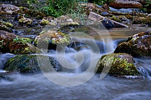 Scenic shot of the flow of a rocky river with a silky water effect
