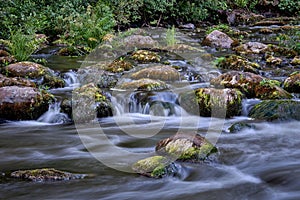 Scenic shot of the flow of a rocky river with a silky water effect