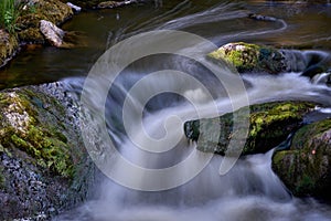 Scenic shot of the flow of a rocky river with a silky water effect