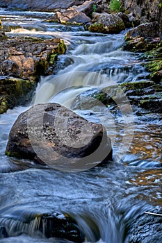 Scenic shot of the flow of a rocky river with a silky water effect