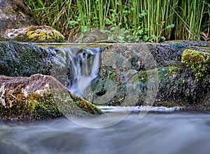 Scenic shot of the flow of a rocky river with a silky water effect