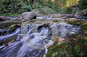 Scenic shot of the flow of a rocky river with a silky water effect