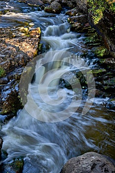 Scenic shot of the flow of a rocky river with a silky water effect