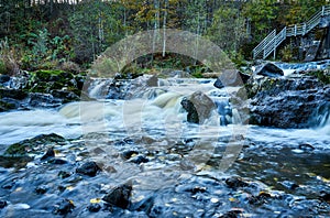 Scenic shot of the flow of a rocky river with a silky water effect