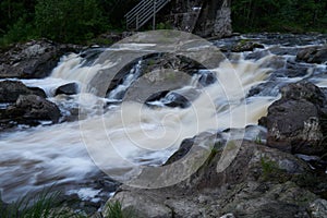 Scenic shot of the flow of a rocky river with a silky water effect