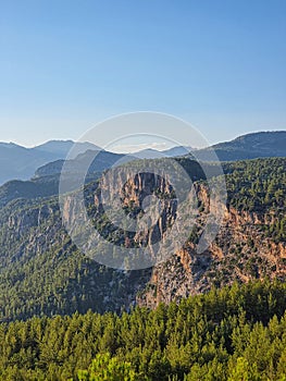 Scenic shot of a forested mountain range between Fethiye and Antalya under blue sky