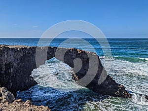 Scenic shot of a natural arch washed by the waters of a sea in Rosarito, California photo