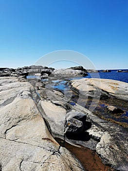 Scenic shot of a sea surrounded by stone mountains in Verdens Ende, Norway