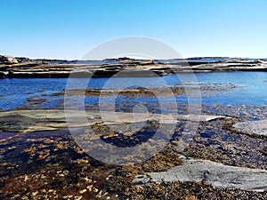 Scenic shot of a sea surrounded by stone mountains in Verdens Ende, Norway