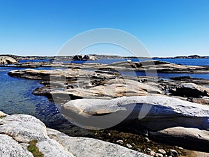 Scenic shot of a sea surrounded by stone mountains in Verdens Ende, Norway