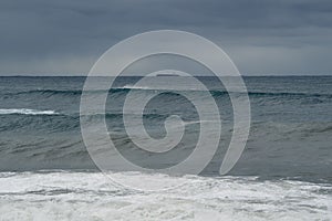 Scenic shot of a surfer catching a large wave at South Maroubra, Australia