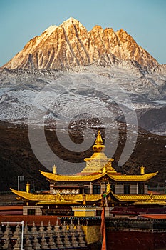 Scenic shot of the Tagong temple and Yala mountain covered in snow in Sichuan, China
