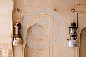 Scenic shot of the two pressurised paraffin lamps hung on a wall photo