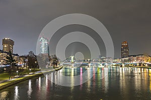 Skyline of Frankfurt by night with river Main photo