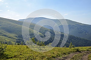 Scenic skyscape with blue sky full of windy clouds, and beautiful green mountains. Carpathians, Ukraine