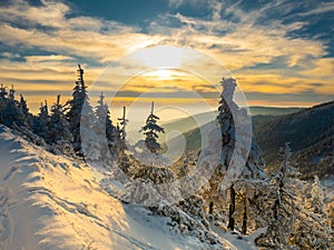 Scenic snowy landscape with a view from a mounatin range to the valley