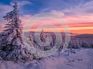 Scenic snowy landscape with a view from a mounatin range to the valley