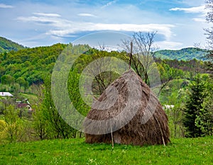 Scenic spring rural landscape with haycock on foreground, Maramures, Romania