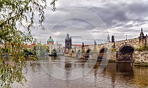 Scenic spring view of the Old Town pier architecture and Charles Bridge over Vltava river in Prague, Czech Republic