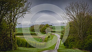 A scenic springtime view of a road winding through the the Lincolnshire Wolds.