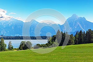 Scenic summer landscape with mountains, lake and forest