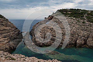 Scenic summer landscape shot in Greece with beautiful cliffs and turquoise sea water