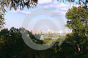 Scenic summer landscape view of Dnipro River and process of construction of high-rise houses on the left bank of Dnipro