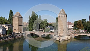 Scenic summer view from Vauban Dam of Petite France quarter, covered bridges and watchtowers on River Ill in city of