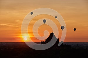 Scenic sunrise with many hot air balloons above Bagan in Myanmar