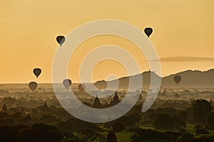 Scenic sunrise with many hot air balloons above Bagan in Myanmar