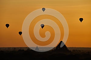 Scenic sunrise with many hot air balloons above Bagan in Myanmar