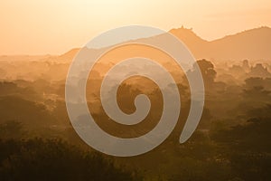 Scenic Sunrise over plain of Bagan on a misty morning