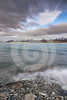 Scenic sunrise view of Lake Pukaki, with their mesmerizing turquoise hue and reflect the majestic snow-capped Southern Alps.