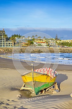 Scenic Sunset with Fishing Boat on Seashore of Playa del Ingles Beach in Maspalomas at Gran Canaria in Spain