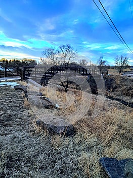 Scenic sunset on the horizon on a walking path with a bridge