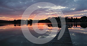 Scenic sunset lake seeon and wooden boardwalk, sunset sky