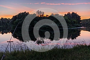 Scenic sunset landscape on the river bank with vibrant colors in the sky