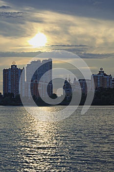 Scenic sunset landscape view of Obolon neighborhood in Kyiv. High-rise buildings near the Dnieper river