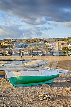 Scenic Sunset with Line of Fishing Boat on Seashore of Playa del Ingles Beach in Maspalomas at Gran Canaria