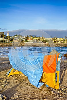 Scenic Sunset with Moored and Covered Fishing Boat on Seashore of Playa del Ingles Beach in Maspalomas at Gran Canaria in Spain