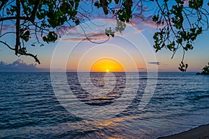 Scenic sunset on Negril Jamaica beach.  Idyllic romantic tropical Caribbean island setting.